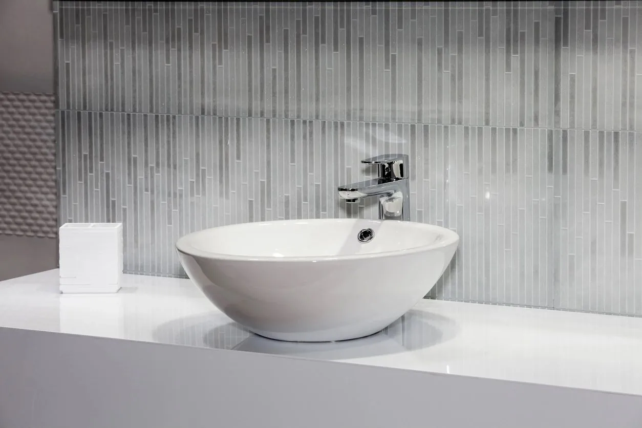 Modern white vessel sink with chrome faucet installation